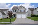 Inviting two-story home with a two-car garage, blue accents and a well-manicured lawn at 4135 Arch Pass, Cumming, GA 30040
