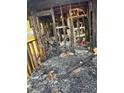 Extensive fire damage is visible, showing charred remains and a need for total reconstruction in bedroom at 447 Martindale Ct, Stone Mountain, GA 30088