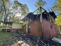 Fire damaged home showing the exterior, with charred wood and structural damage, awaits renovation at 447 Martindale Ct, Stone Mountain, GA 30088