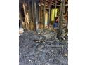 Fire-damaged living room with charred remains and exposed structure is in need of complete restoration at 447 Martindale Ct, Stone Mountain, GA 30088