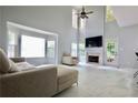 Spacious living room with high ceilings, fireplace, and wall to wall windows at 5996 Eagle Tiff Ln, Sugar Hill, GA 30518