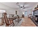 Cozy living room with hardwood floors, ceiling fan, vintage wood-burning stove, and ample seating at 776 Green Dr, Canton, GA 30114