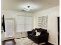 Cozy living area with a modern ceiling fan, comfortable sofa, and bright natural light through window at 870 Mayson Turner Rd # 1207, Atlanta, GA 30314