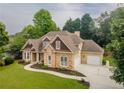 Attractive stone-accented home with manicured lawn, mature trees, and charming curb appeal at 300 Brackin Trce, Grayson, GA 30017