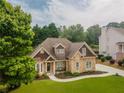 Beautiful home showcasing stone accents, lush lawn, and a welcoming front entrance at 300 Brackin Trce, Grayson, GA 30017