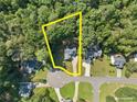 Aerial view showcases property in a wooded area, highlighting lot lines and neighborhood at 6985 Shane Ln, Cumming, GA 30028