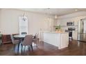 Bright eat-in kitchen features a central island, stainless steel appliances and stylish pendant lighting at 996 Palmetto Sw Ave, Atlanta, GA 30314
