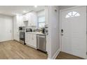 Clean, modern kitchen with white cabinets, stainless steel appliances, and wood-look flooring at 2089 Quilt Ct, Lithonia, GA 30058