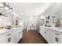 Open-concept kitchen with white cabinets, granite countertops, and stainless steel appliances at 2277 Cloverdale Se Dr, Atlanta, GA 30316