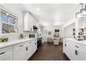 Bright kitchen with white cabinets, stainless steel appliances, and view to the living room at 2277 Cloverdale Se Dr, Atlanta, GA 30316