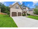 Beautiful home with a lush lawn and a two car garage, showcasing its well-maintained exterior at 7946 White Oak Loop, Stonecrest, GA 30038