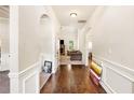 Elegant hallway with hardwood floors, leading to a living room with a fireplace and comfortable seating at 7946 White Oak Loop, Stonecrest, GA 30038