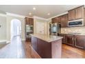 Spacious kitchen featuring a central island, stainless steel appliances, and dark wood cabinetry at 1022 Nestling Dr, Lawrenceville, GA 30045