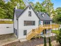 Two-story house with white siding, gray trim, a wooden deck, and a walkout basement at 2552 Hunton Ne Ct, Marietta, GA 30068