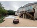 Luxury backyard with a pool, fire pit, and elevated deck at 2609 Jacobs Crest Cv, Grayson, GA 30017