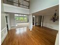 Bright living room with hardwood floors, large windows, and elegant chandelier at 2609 Jacobs Crest Cv, Grayson, GA 30017