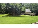 Charming single-story home with lush green lawn and mature trees providing ample shade at 4221 Riverlake Way, Snellville, GA 30039