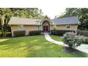 Charming single-Gathering home featuring a landscaped lawn, inviting walkway, and a stucco exterior at 4221 Riverlake Way, Snellville, GA 30039