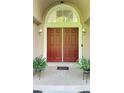 Inviting home entrance featuring a decorative storm door, tiled front porch, and sidelights at 4221 Riverlake Way, Snellville, GA 30039