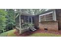 Cozy screened-in porch with access stairs offering a tranquil outdoor living space at 2600 Amberly Dr, Dunwoody, GA 30360