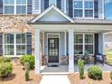 Inviting front porch with stone pillars and cozy seating area, perfect for relaxing at 2953 Balvenie Pl, Acworth, GA 30101
