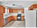 Spacious kitchen featuring stainless steel appliances and light wood cabinetry at 433 Pearl St, Locust Grove, GA 30248