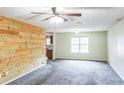 Bright living room featuring neutral walls, plush carpet, and large windows at 433 Pearl St, Locust Grove, GA 30248