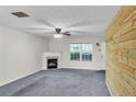 Cozy living room with a fireplace and a decorative wood accent wall at 433 Pearl St, Locust Grove, GA 30248