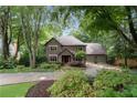 Brick home showcasing an inviting front yard with mature trees at 5049 Lake Ter, Marietta, GA 30068