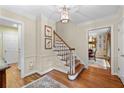 Foyer with hardwood floors, a staircase, and decorative wall paneling at 5049 Lake Ter, Marietta, GA 30068
