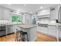 Bright, white kitchen featuring an island, granite countertops, and stainless appliances at 5049 Lake Ter, Marietta, GA 30068