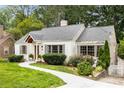 Beautiful home with a well-maintained lawn, a brick exterior, and a welcoming front entrance at 711 Greenview Ne Ave, Atlanta, GA 30305