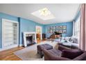 Elegant living room featuring fireplace, piano and skylight at 711 Greenview Ne Ave, Atlanta, GA 30305