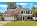 A beautiful two-story home with a brick facade, a well-maintained lawn, and an attached garage at 812 Roget Way, Lawrenceville, GA 30045