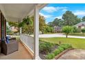 Inviting covered front porch with seating area, perfect for enjoying the neighborhood views at 812 Roget Way, Lawrenceville, GA 30045