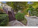 Beautiful landscaped backyard with stone pathway, deck with stairs and lush greenery at 1005 Cromwell Cv, Snellville, GA 30078