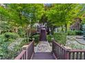 Stone path and steps lead to the backyard with serene and lush landscaping at 1005 Cromwell Cv, Snellville, GA 30078
