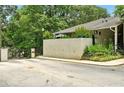 Community entrance featuring a gated entrance and landscaped facade around the leasing office at 1150 Nw Collier Rd # K24, Atlanta, GA 30318