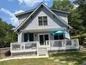 Exterior view of a house showcasing a deck with white railings and outdoor seating at 158 Delano Dr, Decatur, GA 30032