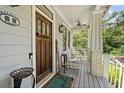 Cozy front porch with rocking chairs, decorative accents, and a wooden door with glass panels at 1589 Delano Dr, Decatur, GA 30032