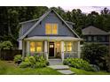Beautiful home with a charming front porch, landscaped yard, and inviting exterior lighting at 1589 Delano Dr, Decatur, GA 30032