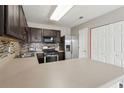 The kitchen features stainless steel appliances, laminate countertops, and a decorative tile backsplash at 163 Silver Fox Trail Trl, Dallas, GA 30157
