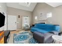 Bright and airy living room boasts a vaulted ceiling, fireplace, and large windows at 163 Silver Fox Trail Trl, Dallas, GA 30157