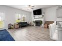 A cozy living area with fireplace, hardwood floors and great natural light at 11689 Mendenhall Ct, Hampton, GA 30228