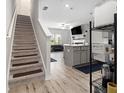 Bright open-concept living area featuring hardwood floors and a staircase at 11689 Mendenhall Ct, Hampton, GA 30228