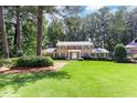 Beautiful two-story brick home boasts a lush green lawn, mature trees, and a classic design at 5287 Vernon Lake Dr, Atlanta, GA 30338