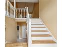 Bright entryway with hardwood floors and a staircase leading to the upper level at 12290 Greenmont Walk, Alpharetta, GA 30009