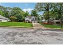Two-story home with lush landscaping and a spacious driveway on a tree-lined street at 12290 Greenmont Walk, Alpharetta, GA 30009