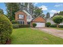 Charming two-story home with a brick and siding exterior, two-car garage and well-manicured front lawn at 3202 Ivy Station Way, Duluth, GA 30096