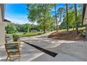 Charming front patio seating area with a long driveway leading to a well-maintained property at 4492 Riverwood Cir, Decatur, GA 30035